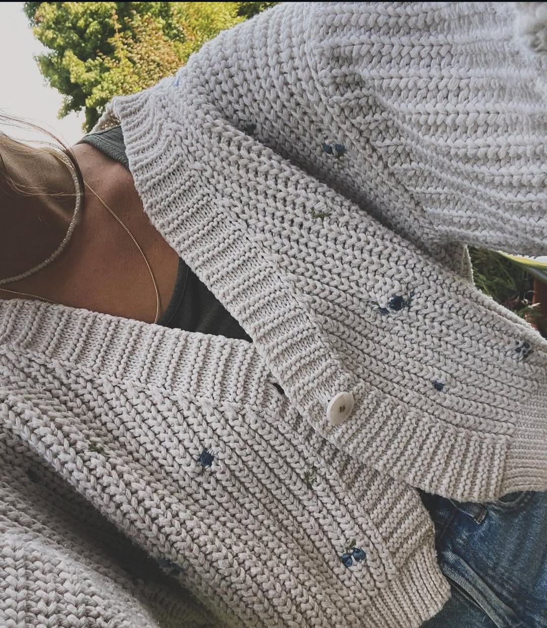 Close-up of a hand embroidered knit cardigan